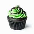 Black cupcake with green frosting and sprinkles on white background. Royalty Free Stock Photo